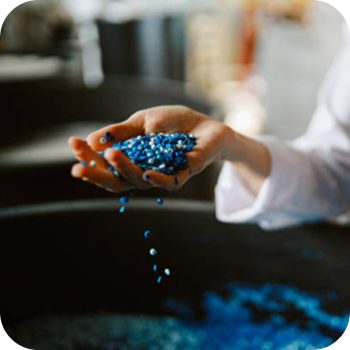 Hand holding blue polymers